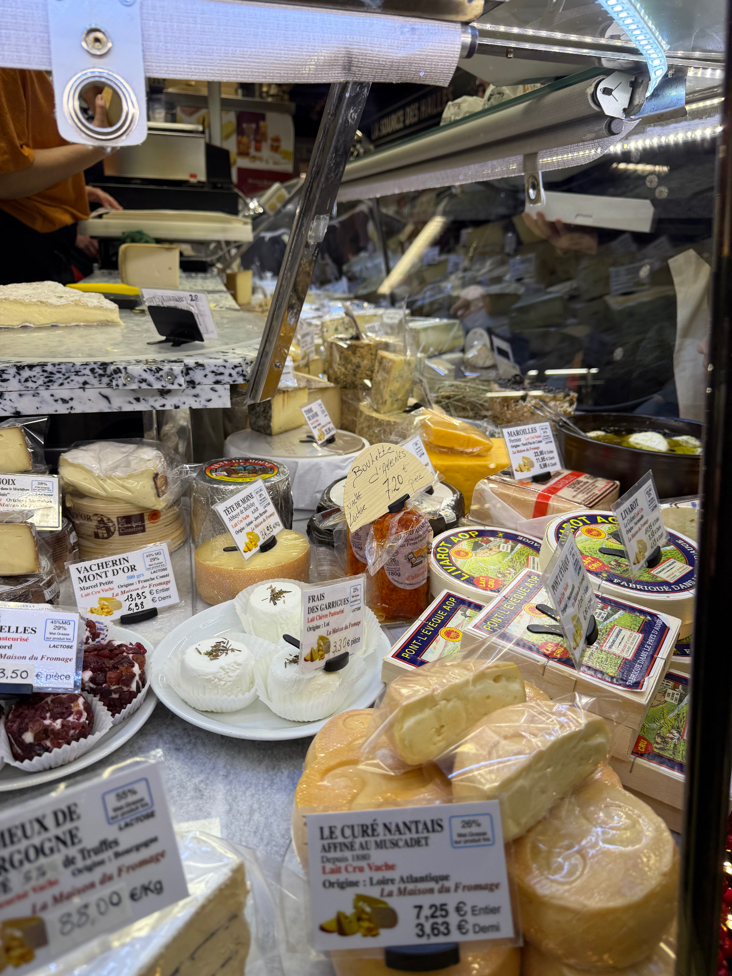 AOP French cheese counter with Vacherin Mont d'Or, Livarot and Pont l'Évêque at a South of France fromagerie